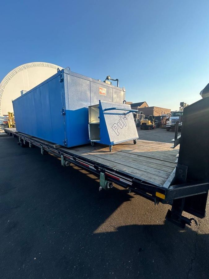 Industrial enclosure on a flatbed for delivery